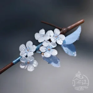 Side view of Jade Skies Chinese hair stick showing layered blue white plum blossom flowers and blue leaf decorations