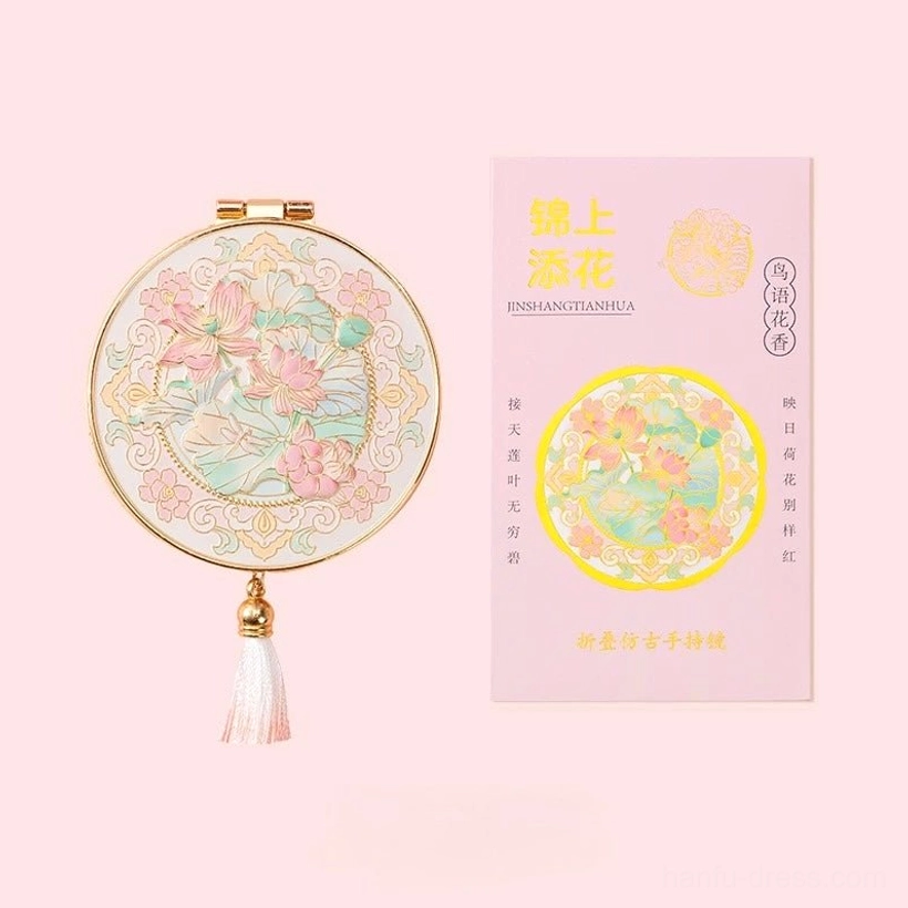 Jin Shang Tian Hua Chinese pocket mirror featuring lotus flower artwork, gold-tone frame, white gradient tassel, and matching cultural product card
