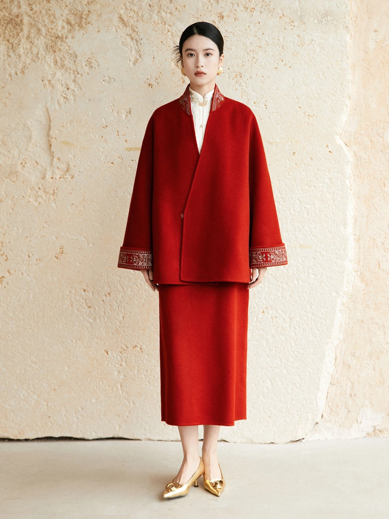 Full front view of jujube red Hanfu inspired wool coat styled with a matching red midi skirt for Chinese New Year