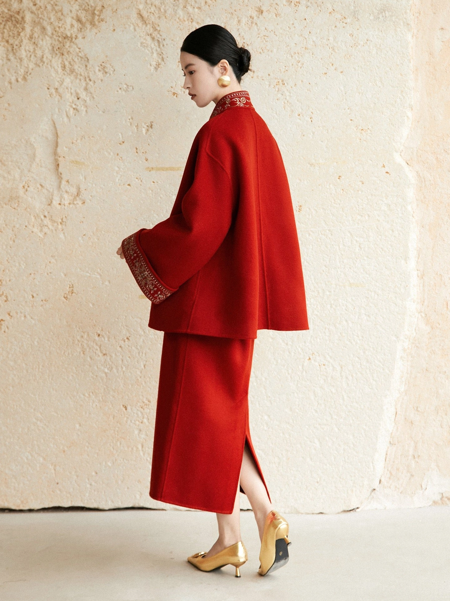 Side back view of jujube red Hanfu wool coat and matching midi skirt showing relaxed silhouette and skirt back slit