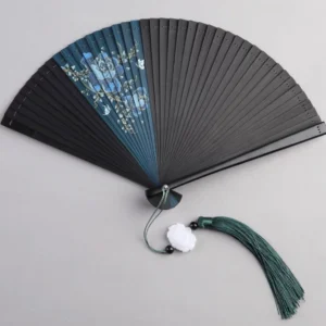 Jupiter blue floral Chinese folding hand fan opened flat with dark bamboo ribs and green tassel on light gray background