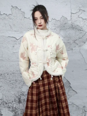 Front three-quarter view of an off-white koi embroidered cropped padded jacket with pink fish embroidery, faux fur trim, Chinese frog buttons, and relaxed modern Hanfu styling