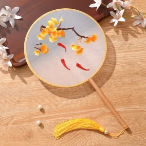 Koi fish and ginkgo embroidered Chinese round hand fan with translucent grey fan face, wooden handle, golden trim and yellow tassel