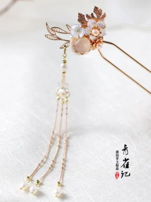 Side view of Kuifen traditional Chinese hair stick showing floral gemstone top and twin long metal chain tassels for Hanfu hairstyle