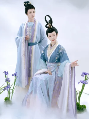 Lady Xiang themed Wei-Jin Dynasty Hanfu couple styling with coordinated blue and lavender traditional Chinese robes, floral embroidery, matching trim, and misty fantasy atmosphere
