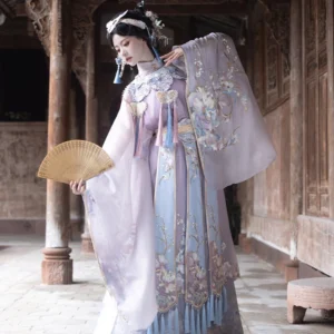 Three quarter view of a lavender Lady Yu Chinese opera inspired Hanfu outfit with sheer sleeves, embroidered bodice, tassel details, and layered mamian skirt
