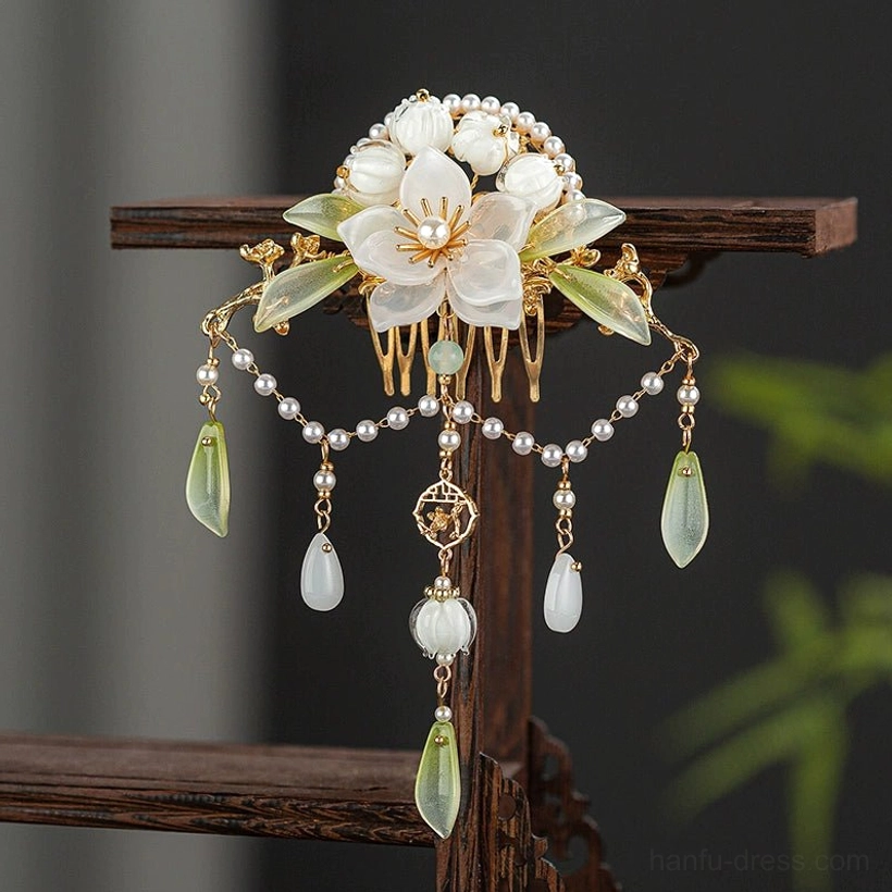 Lanling floral tassel Chinese hair comb close-up with white camellia blossoms, pale green accents, pearl chains and gold tone decorative frame