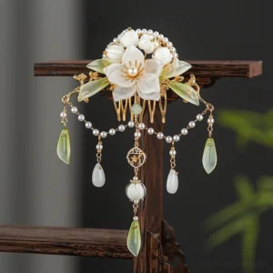 Lanling traditional Chinese Hanfu flower tassel hair comb displayed on a wooden stand with white camellias, pearl border and gold tone details
