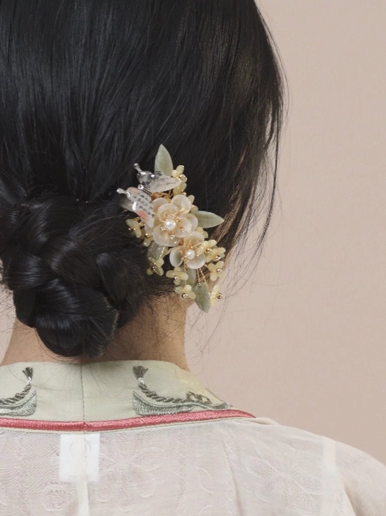 Large Drunk Osmanthus floral Hanfu hair accessory with cream flowers, green leaves, decorative beads, and subtle tassels worn with an embroidered Hanfu outfit