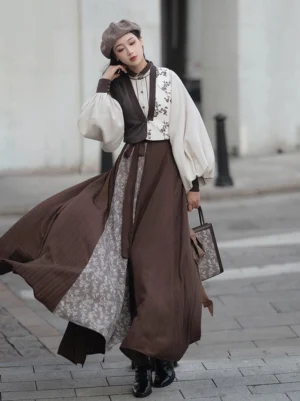 Late Autumn Song-inspired Hanfu outfit worn outdoors with brown vest ivory lantern sleeve blouse and flowing eight-panel skirt