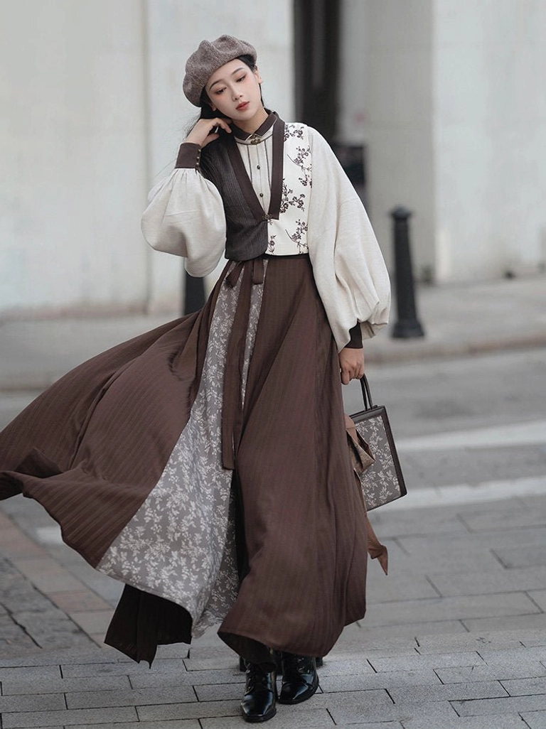 Late Autumn Song-inspired Hanfu outfit worn outdoors with brown vest ivory lantern sleeve blouse and flowing eight-panel skirt