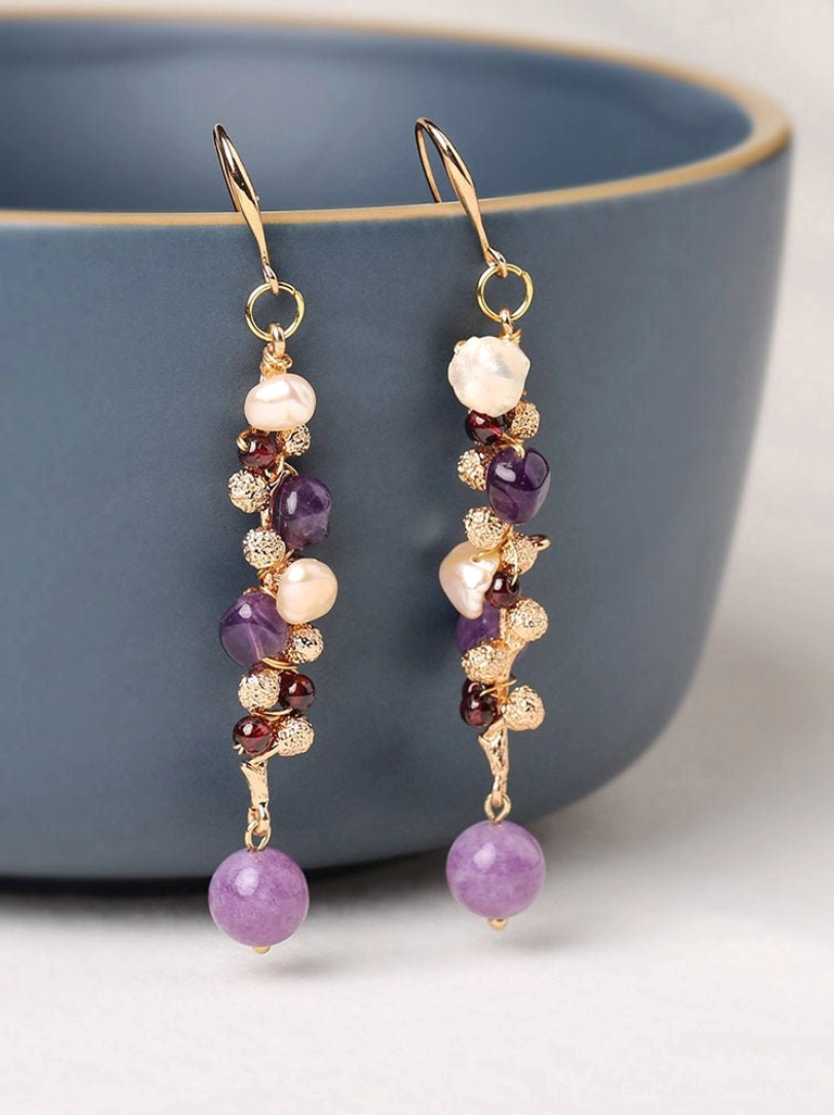 Lavender pearl cluster drop Chinese earrings displayed beside a blue ceramic bowl with violet dangling bead details
