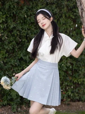 Front view of a light blue pleated mini mamianqun horse face skirt and off-white bow collar top Chinese style outfit