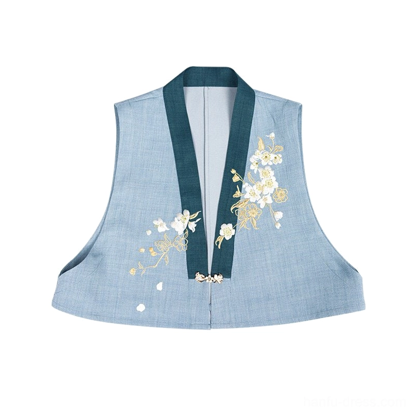 Flat lay detail of light blue Hanfu embroidered vest with dark green V-neck trim, gold and white pear blossom embroidery, and neck hook clasp