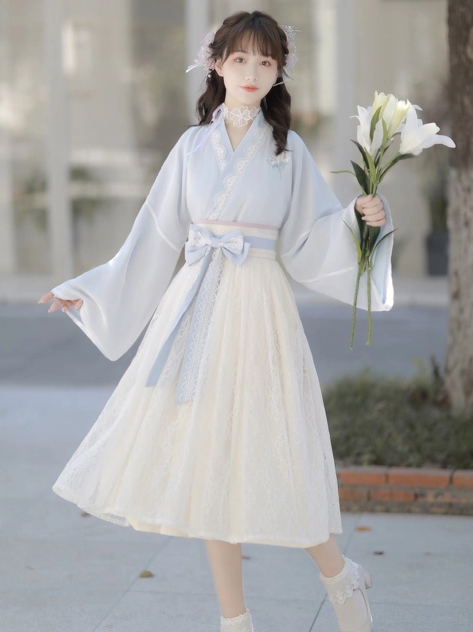 Light blue sweetheart modern Hanfu dress with traditional-inspired cross collar, off-white lace midi skirt and bow sash