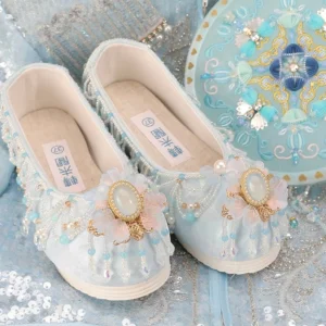 Pair of light blue traditional Hanfu shoes with blue beadwork, decorative tassels, golden accents, rounded upturned toes, and white thick platform soles