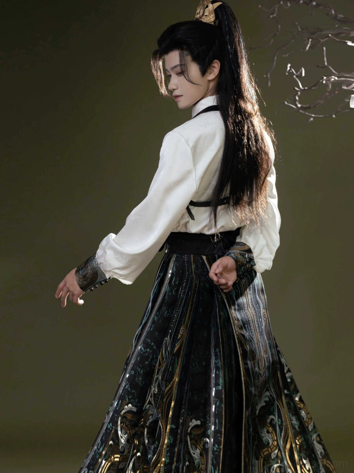 Back three quarter view of white modern Hanfu collar top with shoulder straps and embroidered Ming inspired mamian skirt