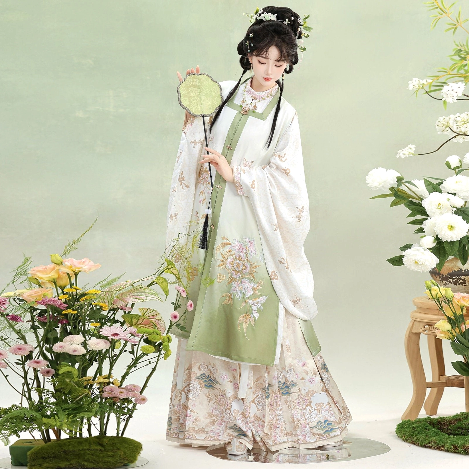 Light green Ming Dynasty Hanfu square collar vest and printed mamian skirt shown from the rear with flowing sleeves