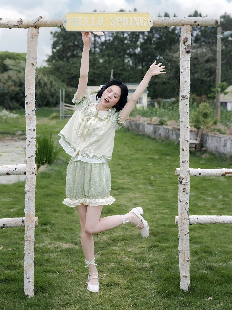 Full front view of a light green Chinese-inspired summer Hanfu outfit with puff sleeves, ruffled bloomers, and sweet Lolita styling on a sunny lawn