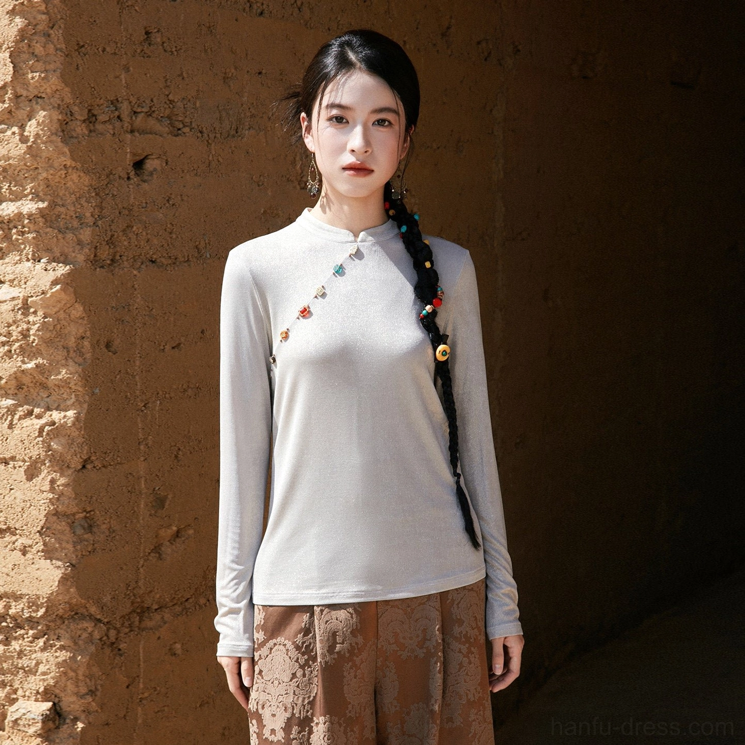 Light grey modern Hanfu women’s satin shimmer long-sleeve top shown in a full front view with slanted buttons and patterned wide-leg trousers