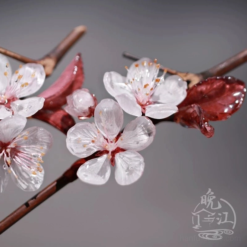 Detailed close-up of Lihua plum blossom hairpin featuring translucent white petals with red edges, glossy dark red foliage, and textured brown shaft
