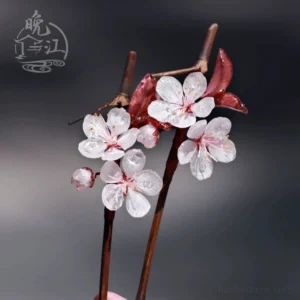 Pair of Lihua plum blossom Chinese hair sticks with translucent white five-petal flowers, dark red leaves, pink buds, and branch-style brown shafts