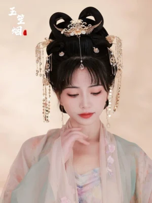 Front close-up of a model wearing the Lijiang Hanfu hair accessories set with a gold phoenix hairpiece, layered tassels, forehead pendant, and floral Hanfu