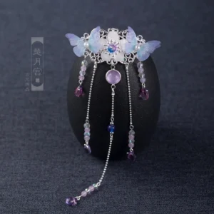 Close-up of a lilac butterfly Chinese Hanfu hair pin with silver-tone filigree, purple-blue resin butterflies, purple beads, and dangling teardrop tassels