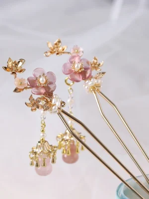 Lilac cherry blossom Chinese hair stick pair with pink resin flowers pearl beads gold toned details and dangling tassels on sheer white fabric