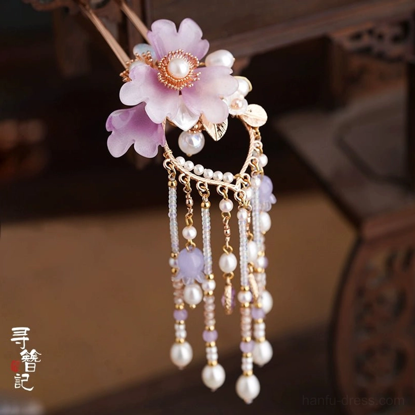 Close-up of Lilac Dream Chinese hair ornament featuring a pearl-centered purple flower, gold accents, and elegant beaded tassel