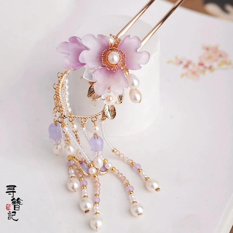 Side view of traditional Chinese lilac flower hair pin with layered pearl tassels, purple beads, gold leaf accents, and dual hair sticks