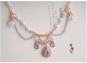 Side view of a Chinese Hanfu style tassel necklace showing the lilac beadwork, freshwater pearl accents, decorative crystal pendant, and layered ornamental structure