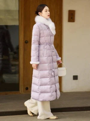 Left side view of a lilac women's Chinese-style winter down coat showing the long silhouette, fluffy fur trim, quilted texture and adjustable drawstring waist