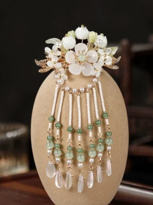 Lily Fountain vintage Chinese hair ornament displayed upright, featuring resin lily flowers, gold-tone leaves, pearl bead tassels, green beads, and pink teardrop charms
