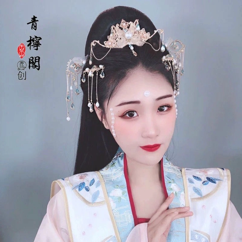 Model wearing blue and white embroidered Hanfu with Linyu floral Chinese hair crown and tassel hairpins in amethyst colorway