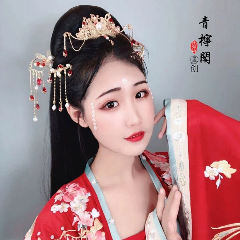 Model wearing red embroidered Hanfu styled with Linyu red floral Chinese hair crown and matching tassel hairpins