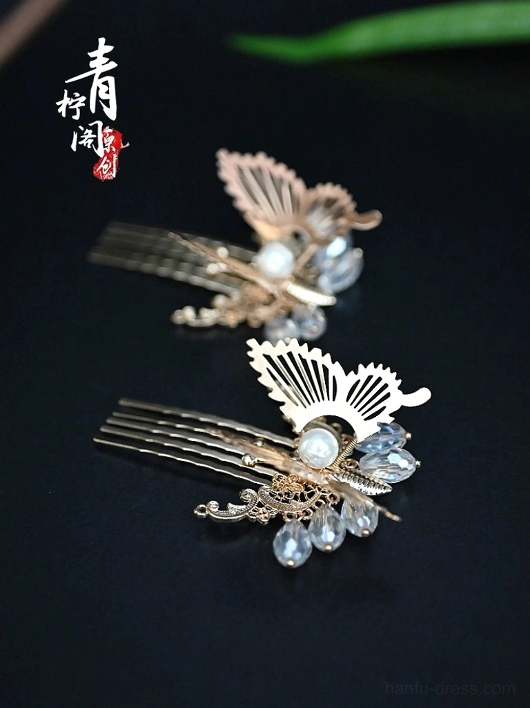 Gold butterfly hair comb pins for Hanfu with openwork wings, faux pearl details, and blue crystal-style hanging pendants