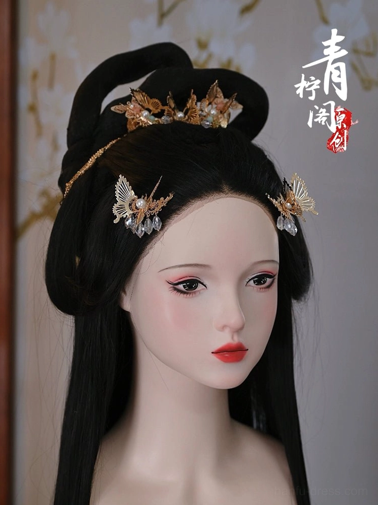 Gold butterfly Chinese hair pins displayed on a traditional Hanfu hairstyle with pearl and blue crystal-style pendants