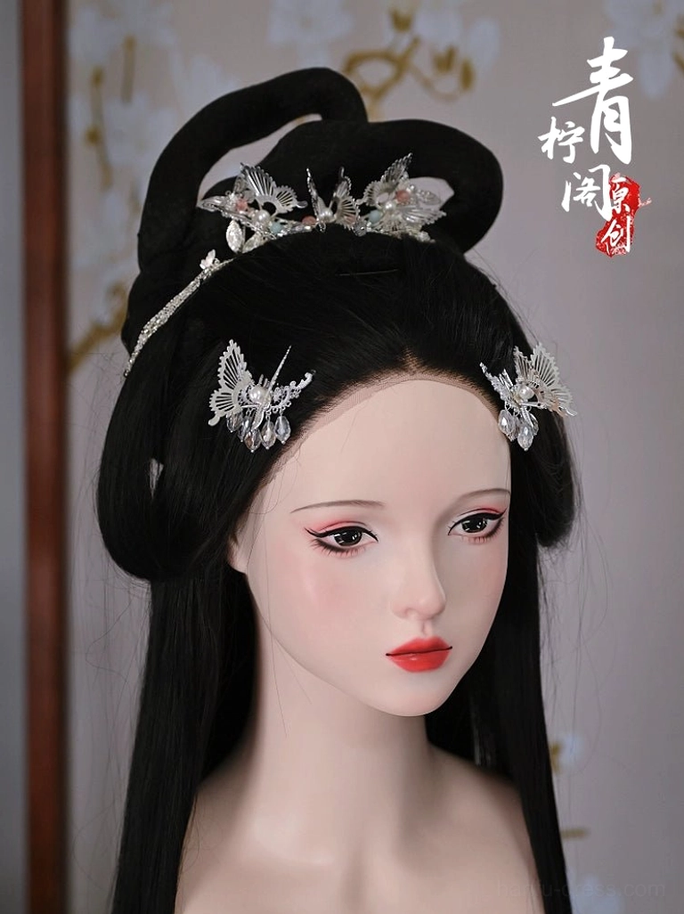 Silver butterfly Hanfu hair pins styled in a traditional Chinese hairstyle with pearl and blue dangling accents