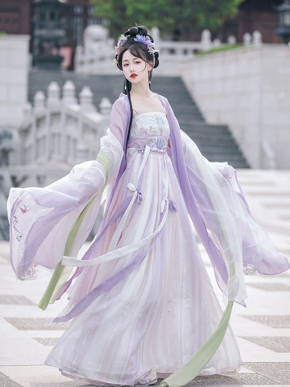 Purple Tang Dynasty Heziqun Hanfu dress side view showing flowing wide sleeves, pale green pibo sash, and long decorative ribbons