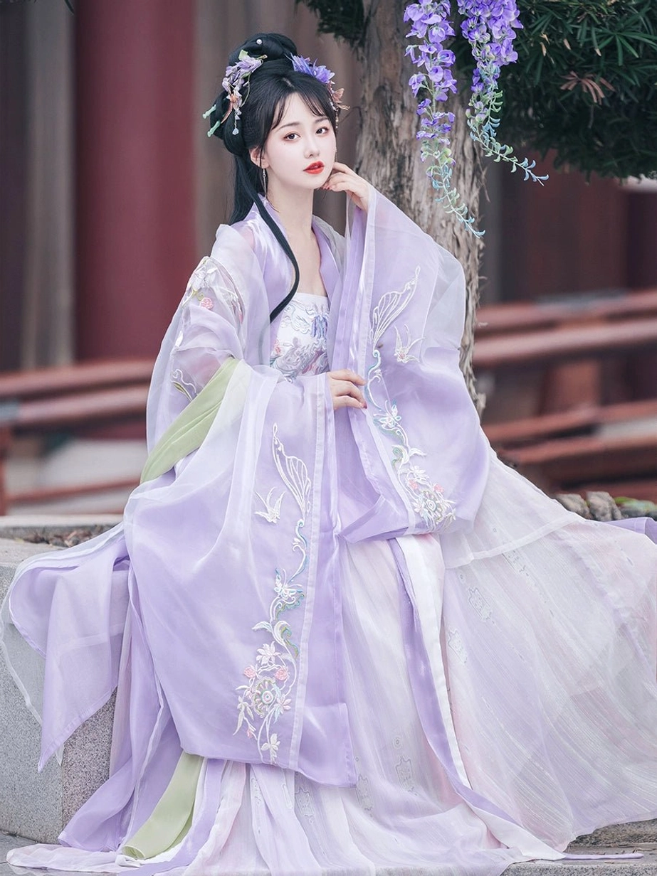 Tang Dynasty inspired purple Heziqun Hanfu seated side view featuring bird and floral embroidered chiffon-look outer coat