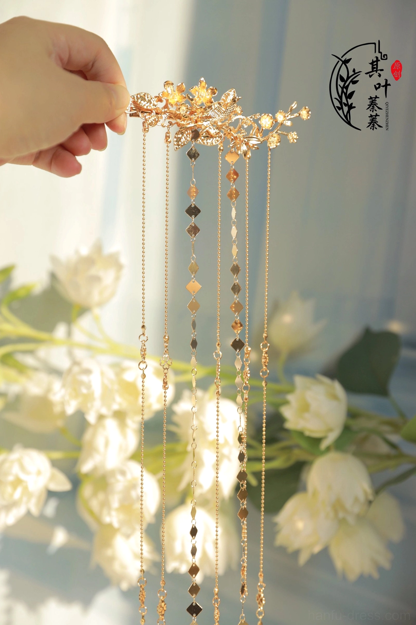 Detailed view of Liudai Hanfu hairpin tassels with multiple fine metal chains, round ornaments, and geometric gold-tone pendants
