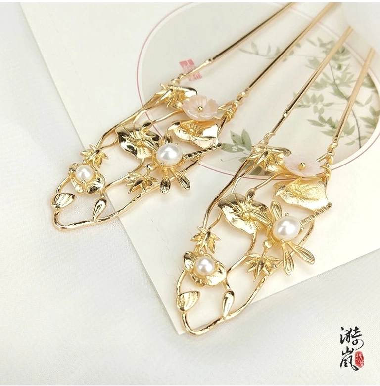 Lixia gold floral double-prong Hanfu hairpins with pink flowers and faux pearl branch details on Chinese style stationery