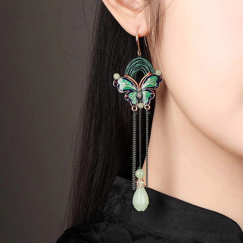 Close up side view of long butterfly teardrop fringe earrings worn with traditional Chinese clothing showing the elegant hanging length