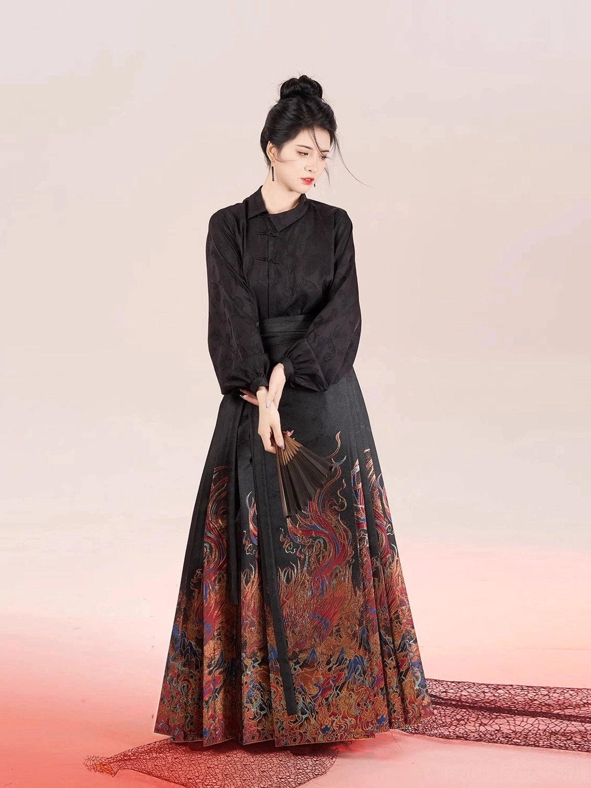 Full-body view of a long-sleeve Chinese hanfu blouse and mamian skirt with fiery mythical creature artwork