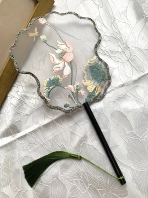Lotus dragonfly embroidered Chinese round hand fan with translucent fan face, dark bamboo handle, green tassel, pink lotus flowers and teal leaves