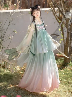 Lotus Fairy Tang Dynasty Hanfu qixiong ruqun in mint green and pink ombre with lotus embroidery, layered top, wide flowing sleeves, and decorative ribbons in a garden setting