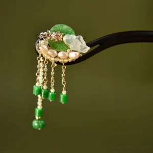 Lotus leaf Chinese hair stick with black pin green jade white lotus pearl beads and gold tassel chains on dark green background