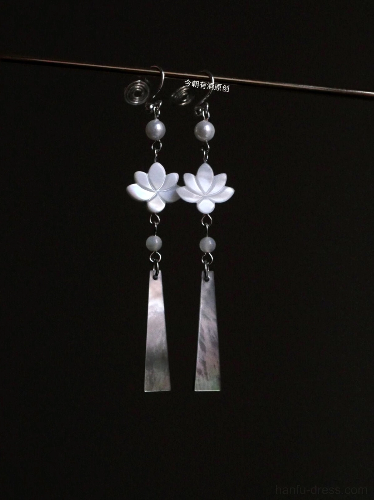 Lotus shell and pearl Hanfu drop Chinese earrings with gray beads and long mother-of-pearl pendants on black background