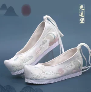 Lunar Bunny embroidered Hanfu platform shoes in off-white canvas with moon cloud motifs, ankle straps, upturned toes, and striped rubber soles